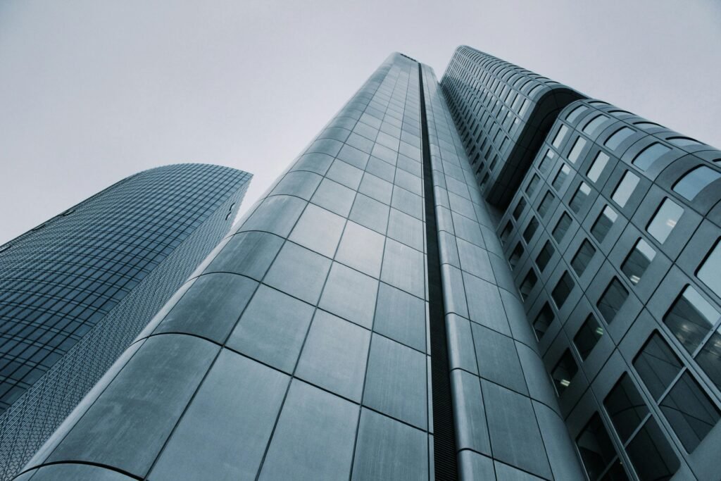 pexels photo 273209 273209 Low angle view of modern skyscrapers with glass and steel design. Perfect for corporate imagery.